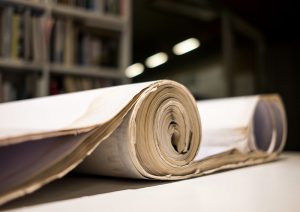 wide format documents rolled up on a table